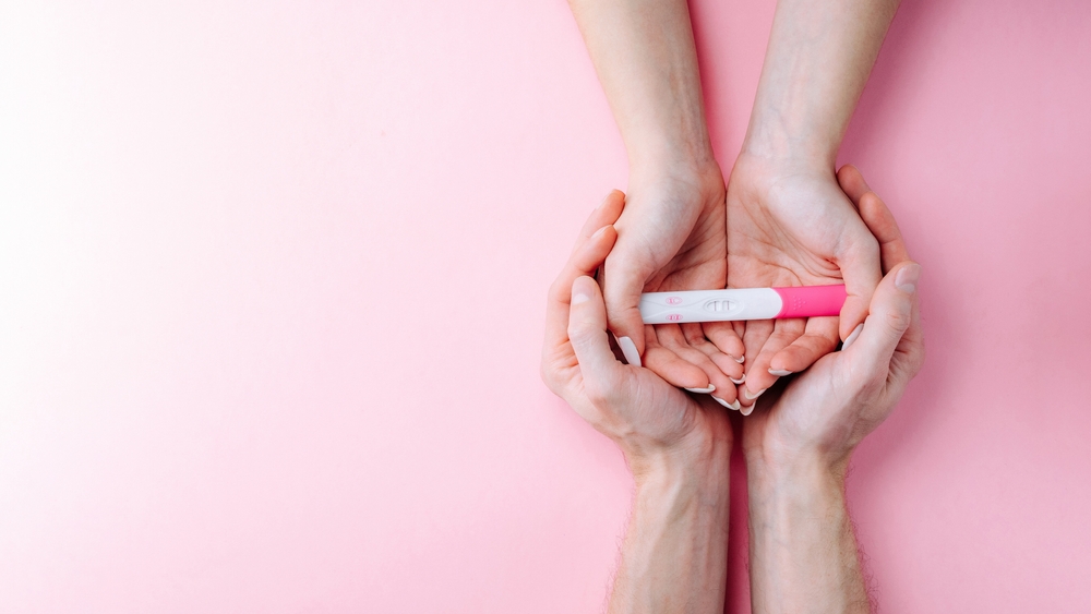 woman holding a pregnancy test.